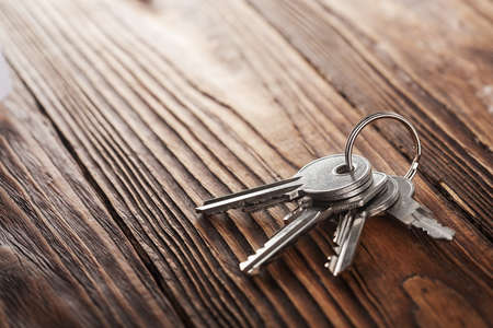 Real estate concept, Key ring and keys on wooden backgroundの写真素材