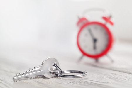 estate concept, keychain with house symbol, red clock, time buyingの写真素材