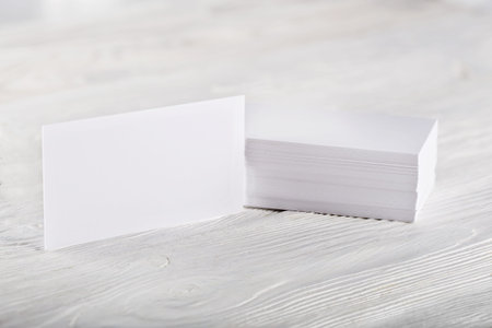 Close Up of two blank horizontal business cards at wooden background