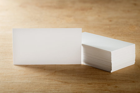 White Blank business card on wooden background. Place for ID