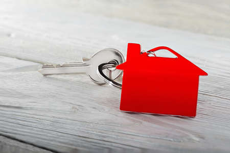 Real estate concept, key chain and keys on wooden backgroundの写真素材