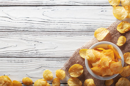 chips potatoes on light old wooden background.concept of fast food and snacksの写真素材