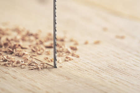 Fret saw cutting wooden oak plank. Jig saw cut clean timber board.の写真素材