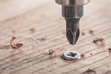 screwdriver screw in a wood oaks plankの写真素材