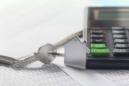 Real estate, keychain with house symbol. Calculator with finance blank.の写真素材