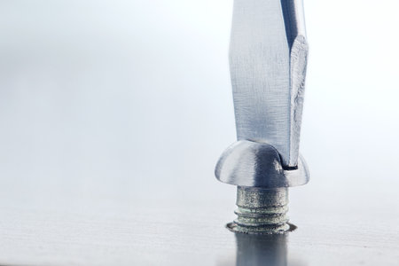 Screwdriver screw in metal steel plate bolt.の写真素材