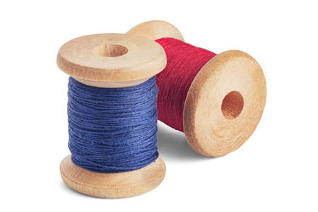 Sewing needle and colorful sewing thread on wooden spool on isolated white backgroundの写真素材