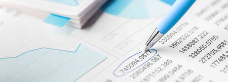 Accounting document with pen, color diagram and checking financial chart. Concept of banking, financial report and financial audit. In blue color.の写真素材