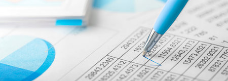 Accounting document with pen, color diagram and checking financial chart. Concept of banking, financial report and financial audit. In blue color.の写真素材