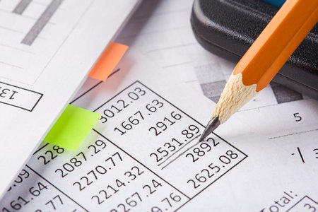 Accounting document with pencil and checking financial chart. Concept of banking, financial report...