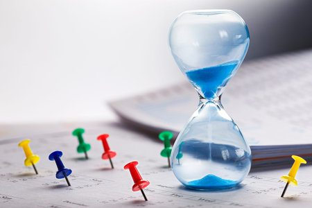 Best time for investment. Hourglass, financial charts, calculator and calendar with pins.