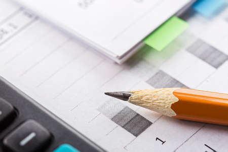 Accounting document with pencil and checking financial chart. Concept of banking, financial report and financial audit.の写真素材