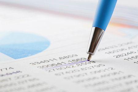 Accounting document with pen, color diagram and checking financial chart. Concept of banking, financial report and financial audit. In blue color.の写真素材