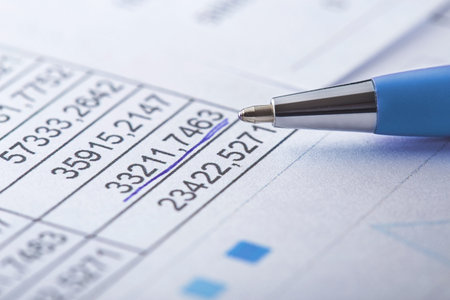 Accounting document with pen, money, coins and checking financial chart. Concept of banking,...