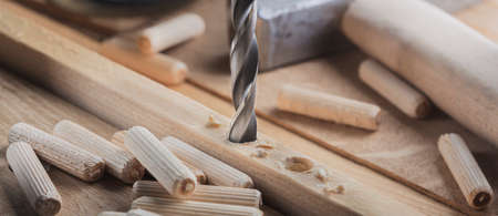 drill bit, hammer, dowel and rasp on wooden oak boardの写真素材