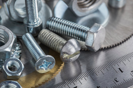 set of different nuts, bolts, screws, washers and drill bits, thread tap and mill cutters on steel...