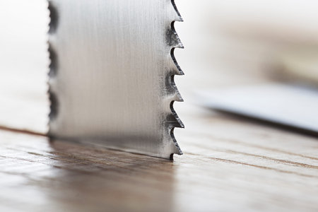 metal band saw cut wood oaks plank with shavings.