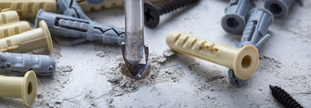 Ceramic drill bit make holes in concrete wall with industrial drill. building work industry.