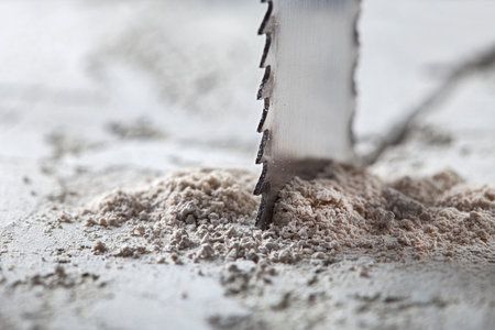 Metal saw, end mill or drill bit with diamond coating makes hole in concrete slab. Industry and construction.の写真素材