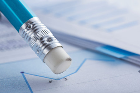 Accounting document with eraser erases blots in the document and checking financial chart. Concept of banking, financial report and financial audit.の写真素材