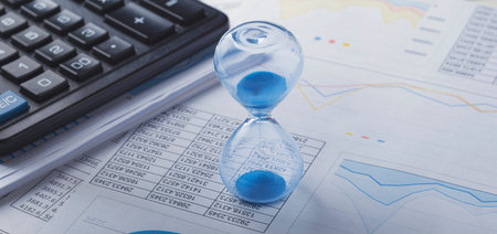 Best time for investment. Hourglass, financial charts and calculator.