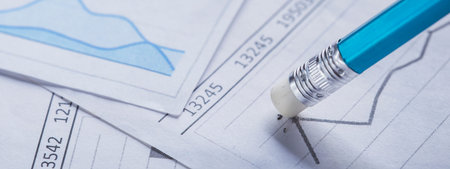 Accounting document with eraser erases blots in the document and checking financial chart. Concept...