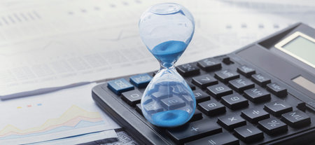 Best time for investment. Hourglass, financial charts and calculator.