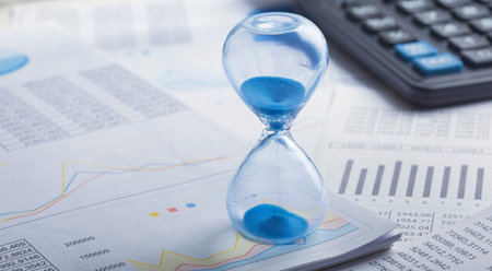 Best time for investment. Hourglass, financial charts and calculator.