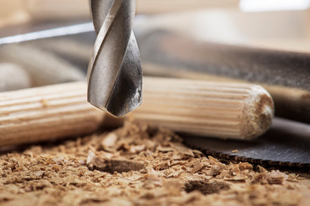 drill bit makes a hole in wooden oak board for wooden dowel.の写真素材