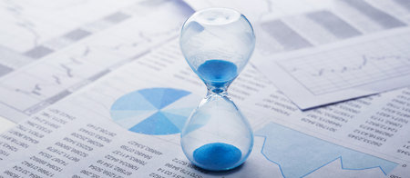 Best time for investment. Hourglass, financial charts and calculator.の写真素材
