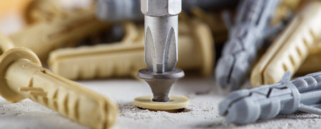 screwdriver screw and dowel in a concrete wall backgroundの写真素材