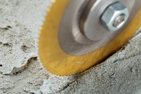 Metal saw, end mill or drill bit with diamond coating makes hole in concrete slab. Industry and...