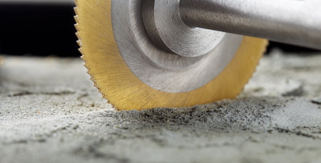 Metal saw, end mill or drill bit with diamond coating makes hole in concrete slab. Industry and construction.の写真素材