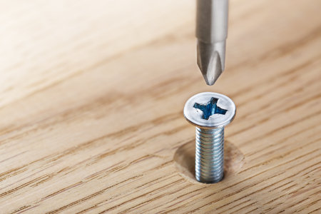 screwdriver screw in a wood oaks plankの写真素材