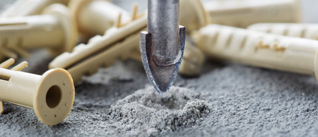 metal drill bit make holes in concrete wall on industrial drilling