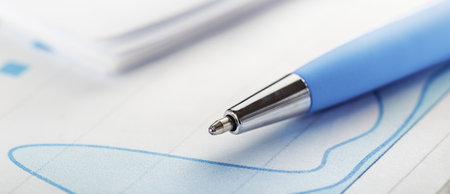 Accounting document with pen, money, coins and checking financial chart. Concept of banking, financial report and financial audit.の写真素材