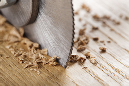 Circular saw cutting wooden plank. Circular milling in oak block.の写真素材