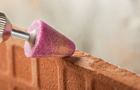 grinding bevel of ceramic tiles by grinding stone using drill.