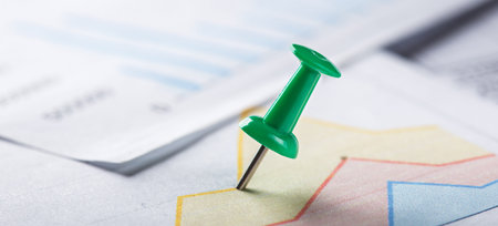 Marking financial chart by pins.Share listing and checking financial chart. Concept of banking, financial report and financial audit.の写真素材