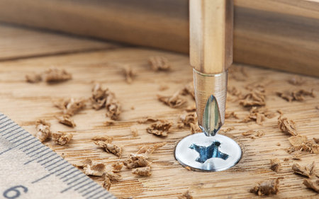 screwdriver screw in a wood oaks plank