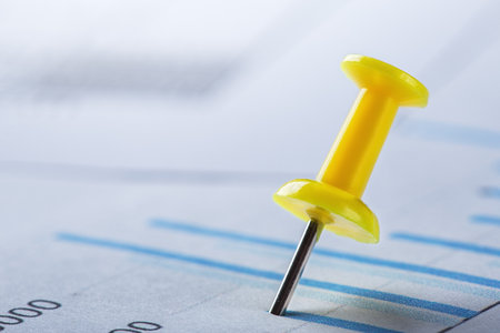 Marking financial chart by pins.Share listing and checking financial chart. Concept of banking, financial report and financial audit.の写真素材