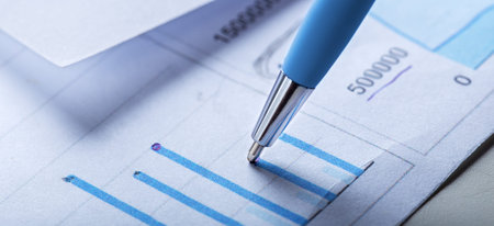 Accounting document with pen, money, coins and checking financial chart. Concept of banking,...