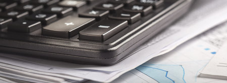 calculator and financial charts. Investment and capital accumulation concept