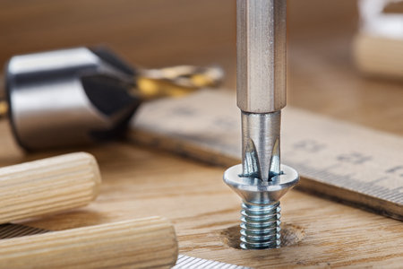 screwdriver screw in a wood oaks plankの写真素材