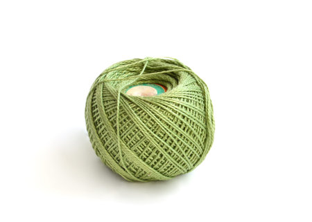  green wool ball on a white background の写真素材