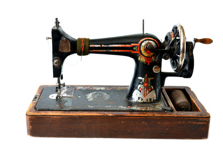 isolated antique sewing machine on white 