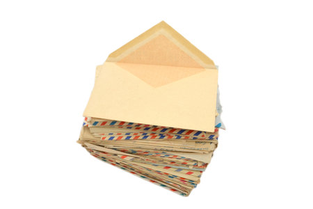 pile of old letters in post envelopes on a white background