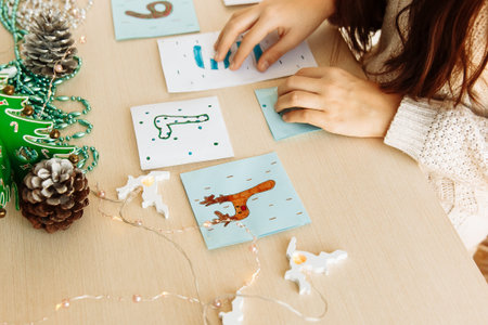 a child makes a Christmas advent calendar out of paper with his own hands diy close up