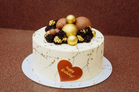 white cake with the inscription Happy Birthday