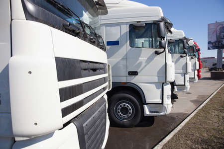 White trucks stand in lineの写真素材